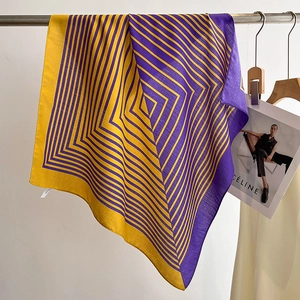 Detail of yellow and purple geometric striped scarf with soft cotton-linen texture