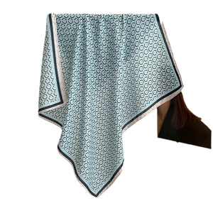 Elegant light blue silk neck scarf featuring black ring patterns and contrast borders