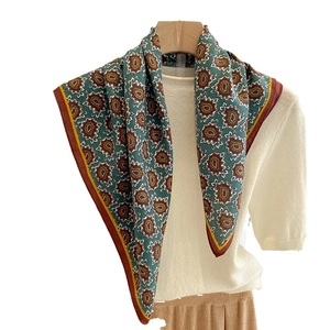 Elegant paisley square scarf in teal silk-like fabric with warm floral patterns