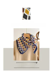 Detail view of cotton linen square scarf with navy blue and brown diamond check pattern