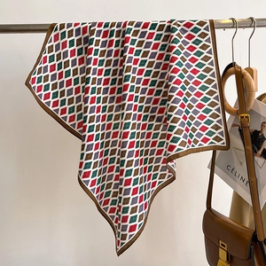 Close-up of vintage argyle silk scarf with satin luster hanging on a metal rod
