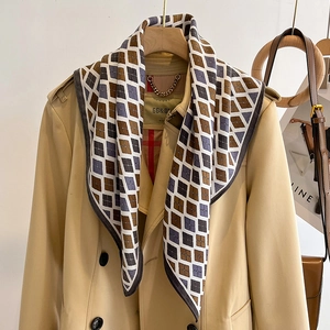 Elegant diamond pattern silk scarf styled with khaki trench coat for a chic French look