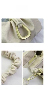 Close-up of cream textured cloud bag featuring golden hardware and ruched strap details