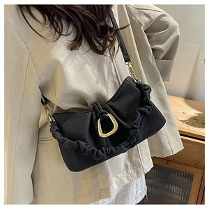 Close-up of black pleated cloud bag featuring a premium gold D-ring buckle and PU texture