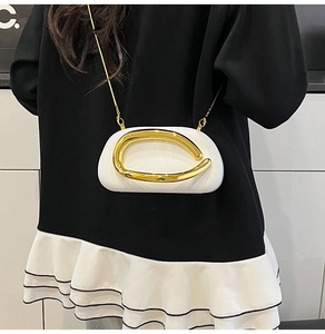 Chic white box clutch with oversized irregular gold circular ring and chain strap on shoulder
