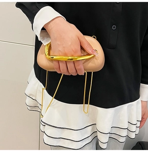 Nude leather evening clutch with chunky gold ring handle and metal chain strap