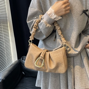Minimalist pleated cloud underarm bag in beige textured fabric with gold D-ring buckle