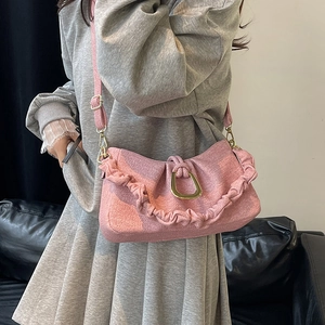 Pink ruched cloud shoulder bag with gold D-ring buckle and adjustable strap