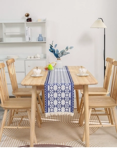 Close-up of blue and white geometric table runner with white decorative tassels