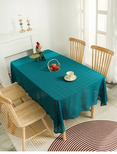 Detail of peacock blue lace tablecloth with hollow weave and elegant scalloped edges