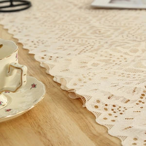 Vintage cream lace table runner with hollow geometric patterns and wavy edges