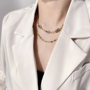 Close-up of double-layered gold and silver mixed pig nose chain necklace on model