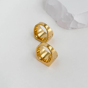 Detail view of gold polished square signet ring with hollow side rectangular patterns