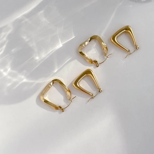 Minimalist gold geometric U-shaped and triangle stud earring set with a polished mirror finish