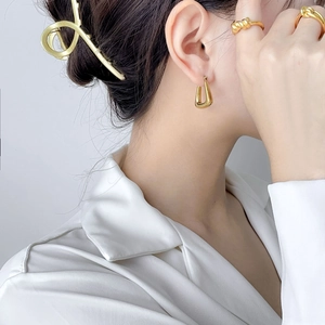 Minimalist gold geometric earrings and ring set shown on model for a refined luxury look