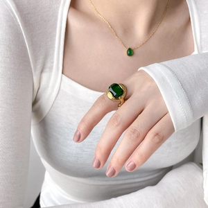 Luxurious gold jewelry set with square emerald gemstone ring and matching necklace