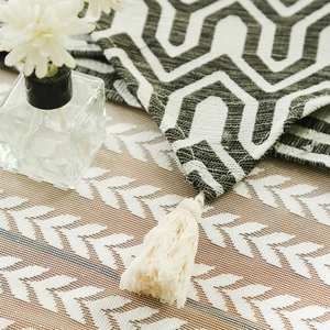 Modern Zen cotton linen table runner with black and white geometric maze patterns and tassels