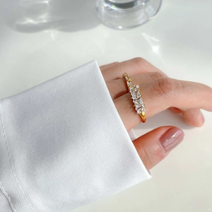 Close-up of elegant gold zircon ring worn by a model with a clean minimalist aesthetic
