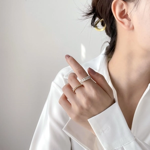 Elegant gold-plated stackable rings featuring square-cut zircon stones on a model's hand