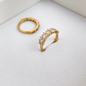 Close-up of gold-plated rings with rectangular zirconia set in a claw setting