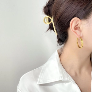 Close-up of layered golden double circle earrings on model for a minimalist modern look