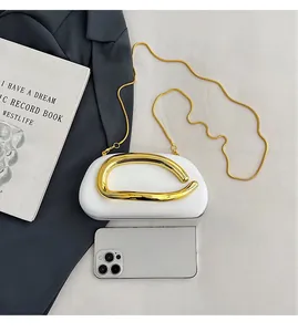 Detailed comparison of white crossbody bag with gold metal handle and smartphone