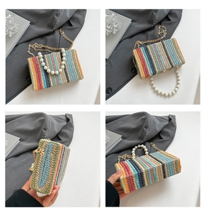 Detail of colorful woven straw bag with pearl handle and gold chain strap