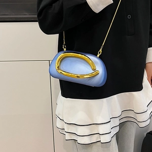 Light blue oval box bag with oversized gold metal handle and chain shoulder strap