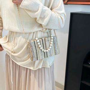 Striped straw crossbody bag with pearl handle and metal chain strap for women