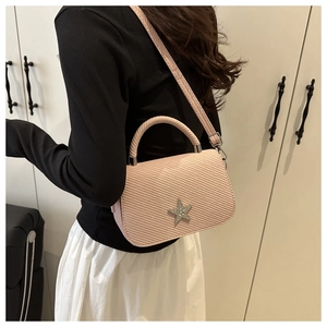 Detail of pink small square bag with rhinestone star buckle and adjustable strap
