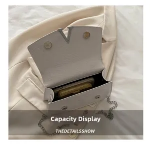 Interior view of white crocodile pattern bag showing phone and wallet storage space