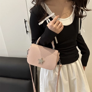 Pink quilted crossbody handbag with star-shaped diamond buckle and elegant handle