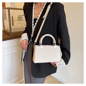 Detail of lychee pattern leather handbag with silver hardware and adjustable strap