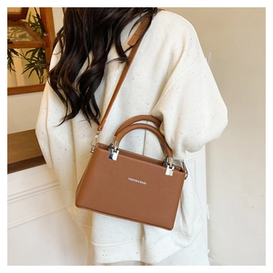 Macro detail of caramel brown lychee grain leather handbag with Fashion & Bags text