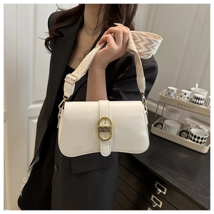 Detail of white square crossbody bag with vintage gold buckle and geometric woven strap