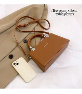 Caramel brown lychee leather handbag with a smartphone for size reference