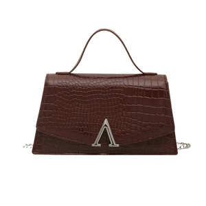 Deep brown crocodile pattern crossbody bag with silver metal buckle on white background