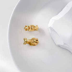 Close-up of gold chain rings showing polished finish and intricate snake pattern detail