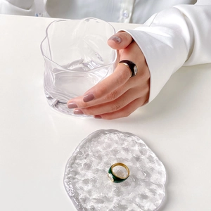 Detail of vintage enamel Möbius rings with crystal inlay on a minimalist background