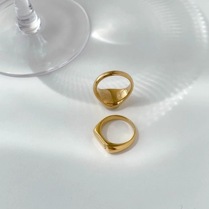 Detailed view of two vintage gold signet rings on a clean artistic white background