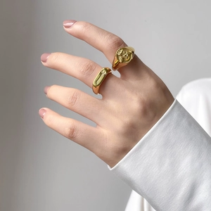 Vintage gold signet rings with angel relief and cross engraving for a minimalist aesthetic