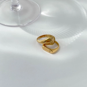 Detailed view of vintage gold rings featuring classical portrait relief and floral engraving
