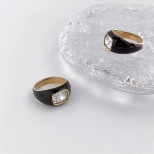 Detail of Mobius ring with black enamel, gold metal base and square zircon stones