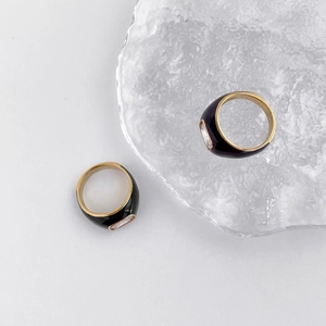 Detail of Mobius ring with black enamel finish and emerald cut cubic zirconia stone