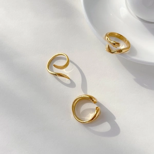 Detailed view of three minimalist 18K gold plated rings with sleek abstract snake designs