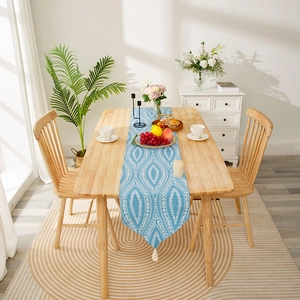 Blue modern table runner with white geometric leaf pattern and decorative tassels