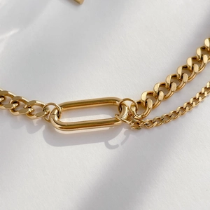 Close-up of gold cuban link chain and thin cable chain with rectangle clasp connector