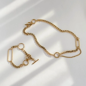 Gold chain jewelry set with chunky necklace and bracelet featuring an OT toggle clasp