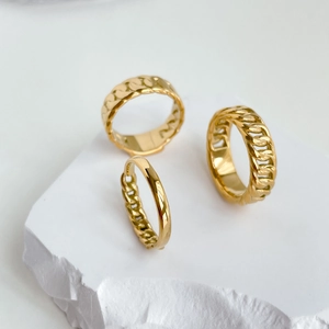 Three-piece set of golden chain rings featuring minimalist Cuban and woven link designs