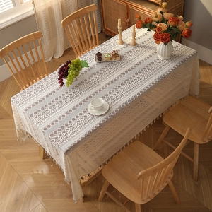 Bohemian lace tablecloth with floral hollow patterns and elegant tassel edge on wood table